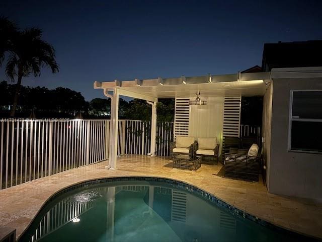 pool at twilight featuring a pergola and a patio