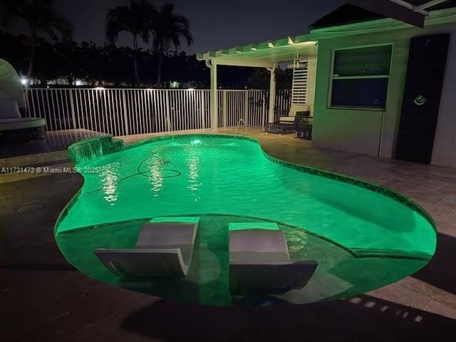 pool at twilight featuring a patio