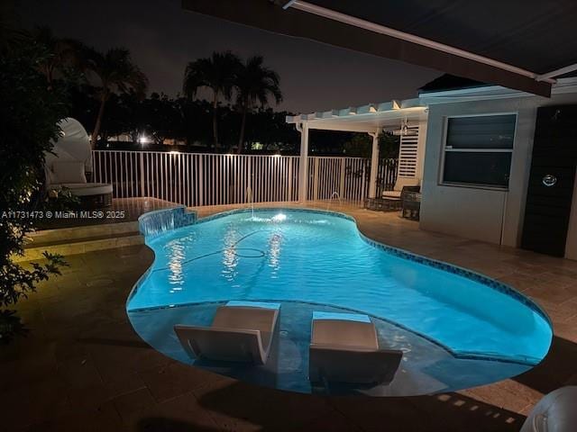 pool at twilight featuring a pergola, a patio area, and pool water feature