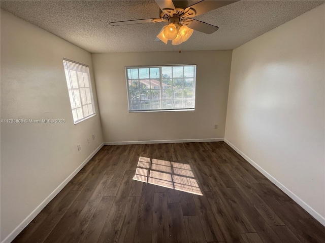 spare room featuring ceiling fan, dark wood-type flooring, and a textured ceiling