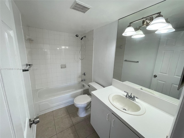 full bathroom with tile patterned flooring, vanity, tiled shower / bath combo, and toilet