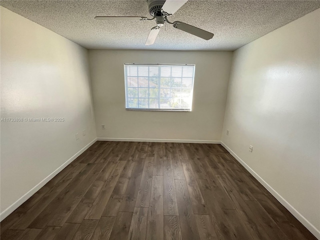 empty room with ceiling fan, dark hardwood / wood-style floors, and a textured ceiling