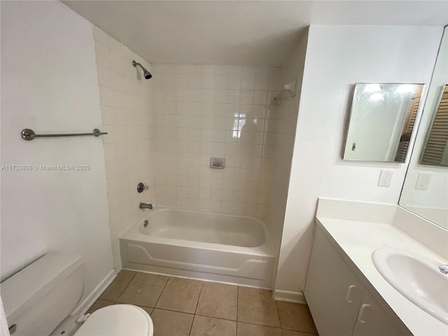 full bathroom with tile patterned flooring, tiled shower / bath, vanity, and toilet