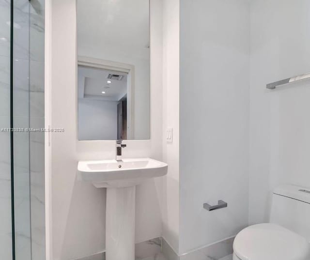 bathroom featuring sink and toilet