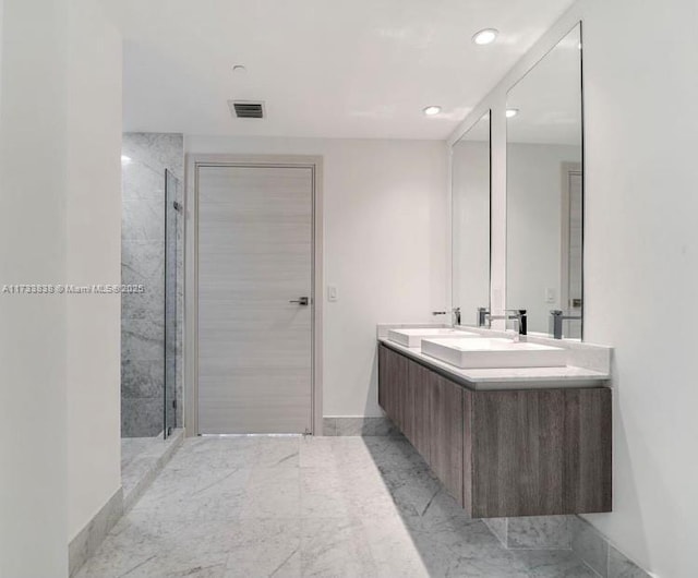 bathroom featuring vanity and tiled shower