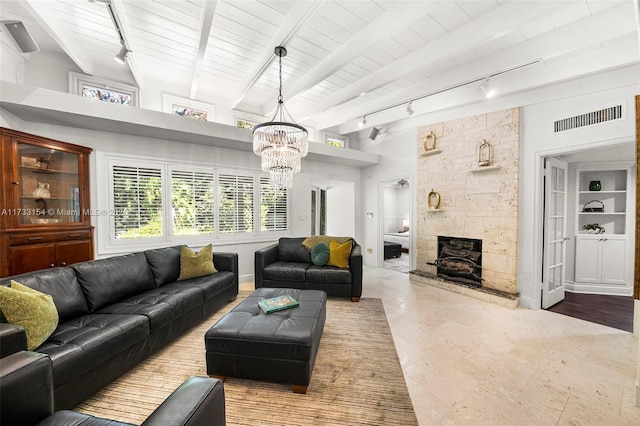 living room featuring an inviting chandelier, a stone fireplace, wooden ceiling, and beamed ceiling