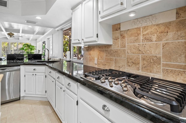 kitchen with backsplash, appliances with stainless steel finishes, sink, and white cabinets