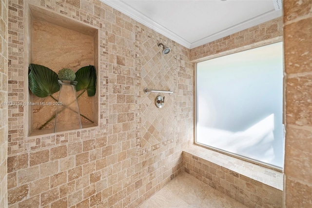 bathroom featuring a tile shower and crown molding