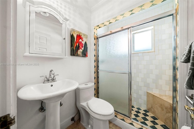 bathroom with ornamental molding, an enclosed shower, and toilet