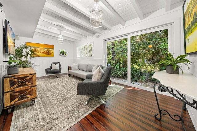 sunroom featuring lofted ceiling with beams and wooden ceiling