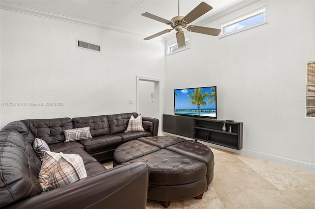 living room with crown molding, a textured ceiling, and ceiling fan