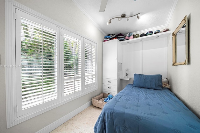 bedroom featuring a textured ceiling, ornamental molding, and ceiling fan