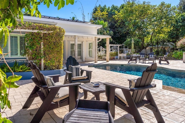 view of pool featuring an outbuilding and a patio area