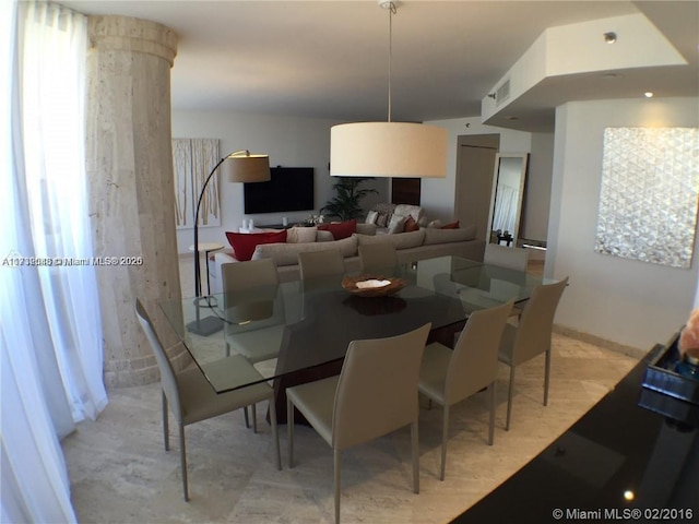 dining area featuring light wood-style floors and visible vents