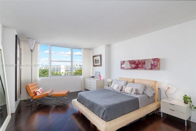 bedroom with dark hardwood / wood-style floors