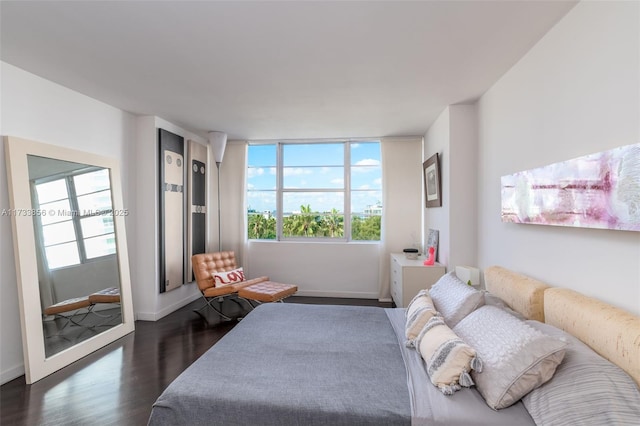 bedroom with dark wood-type flooring