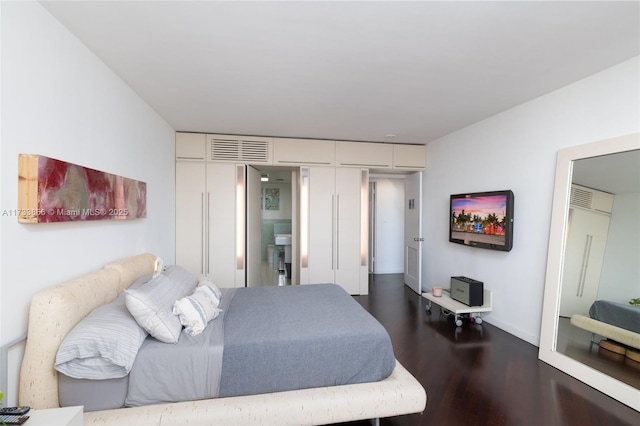 bedroom with dark hardwood / wood-style floors