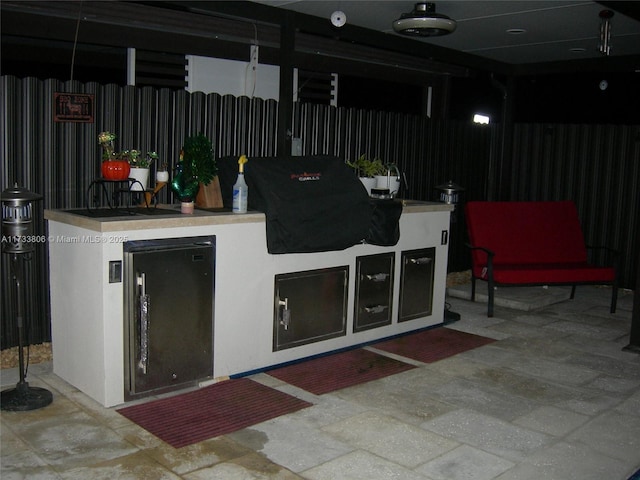 interior space with a bar and exterior kitchen