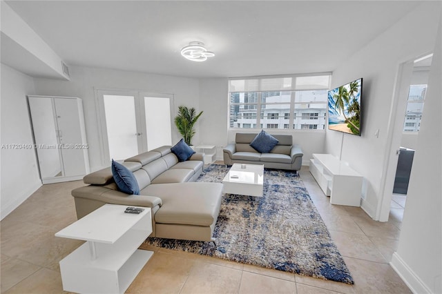 tiled living room featuring french doors