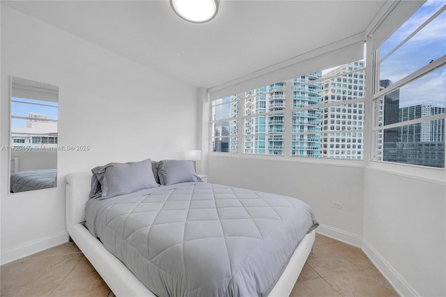 tiled bedroom featuring multiple windows