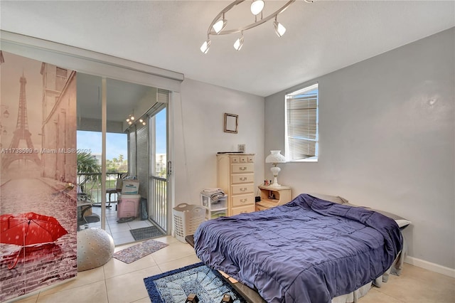 bedroom featuring light tile patterned floors and access to exterior