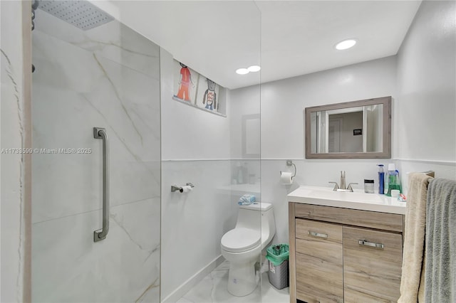 bathroom with a shower, vanity, and toilet