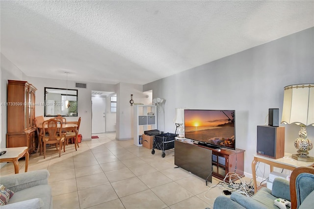 living room featuring light tile patterned flooring and a textured ceiling