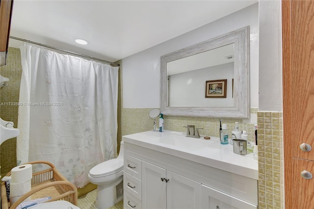 bathroom with vanity, tile walls, a shower with shower curtain, and toilet