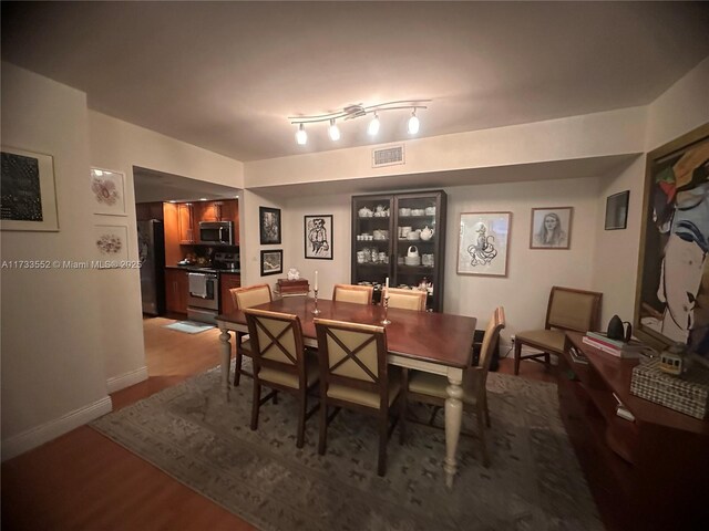 dining space with hardwood / wood-style flooring