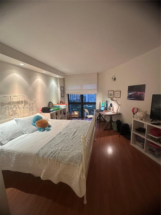 bedroom with dark hardwood / wood-style floors