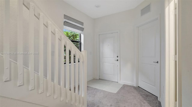 view of carpeted entrance foyer