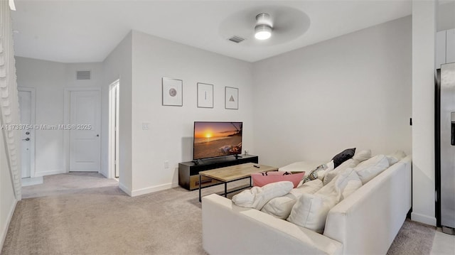 living room featuring light colored carpet and ceiling fan