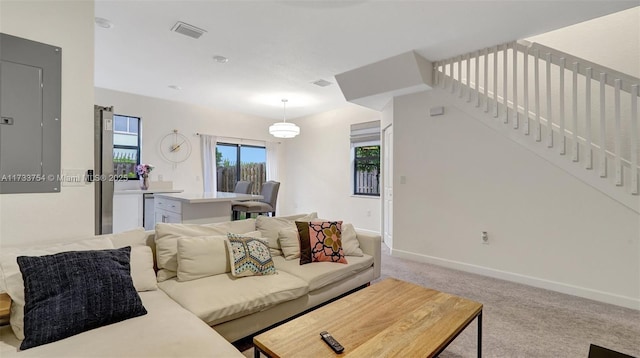 carpeted living room featuring electric panel