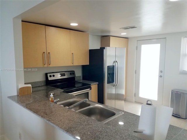 kitchen with visible vents, appliances with stainless steel finishes, light brown cabinetry, a sink, and recessed lighting