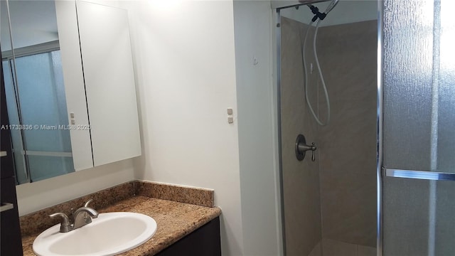 full bathroom with a stall shower and vanity