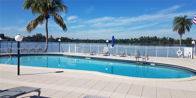 community pool with a patio and fence