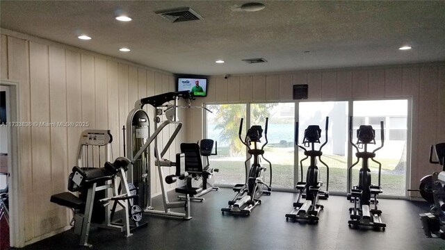 exercise room featuring a textured ceiling