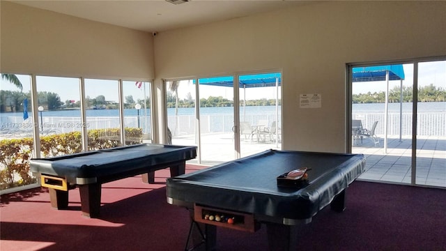 rec room with carpet floors, a water view, and billiards