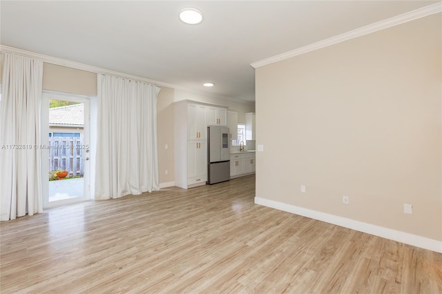 unfurnished living room with baseboards, ornamental molding, recessed lighting, and light wood-style floors