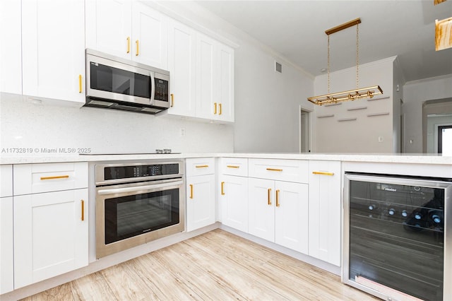 kitchen featuring wine cooler, white cabinetry, stainless steel appliances, and light countertops