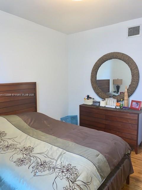 bedroom with hardwood / wood-style floors