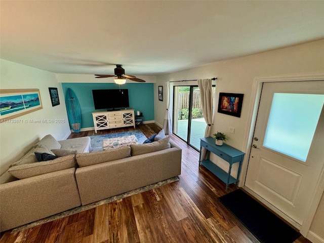 living room with dark wood-type flooring and ceiling fan