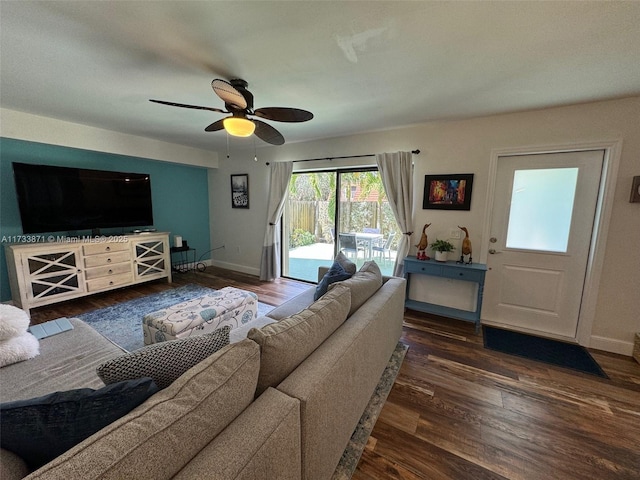 living room with ceiling fan and dark hardwood / wood-style flooring