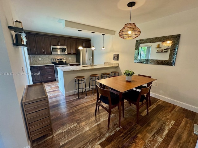 dining area with sink and dark wood-type flooring