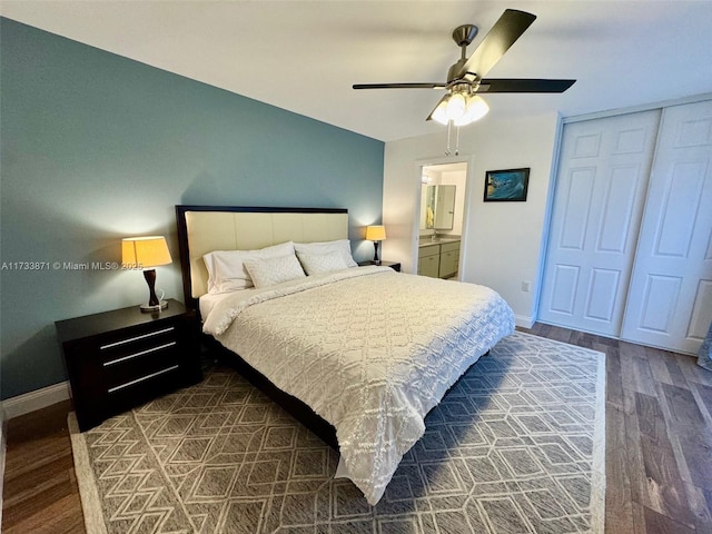 bedroom with ceiling fan, connected bathroom, dark hardwood / wood-style floors, and a closet