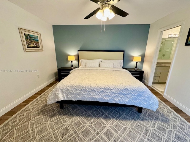 bedroom featuring hardwood / wood-style flooring, ceiling fan, and ensuite bath