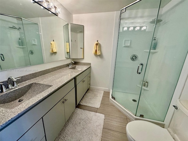 bathroom with vanity, toilet, and walk in shower