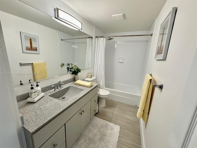 full bathroom with shower / bath combination with curtain, vanity, and toilet