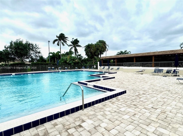 view of swimming pool with a patio