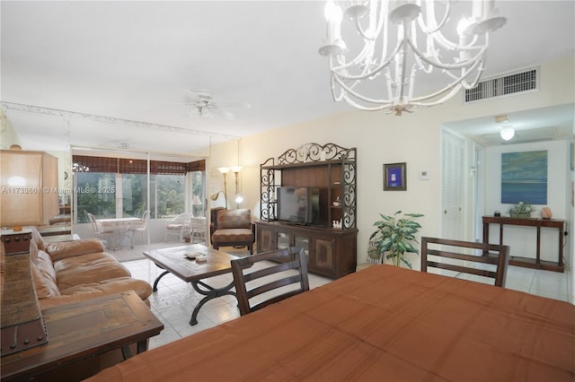 living room featuring ceiling fan with notable chandelier and light tile patterned flooring